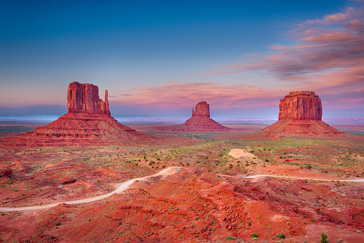 Beautiful dramatic sunset over the East, West Mitten Butte and Merrick Butte in Monument Valley