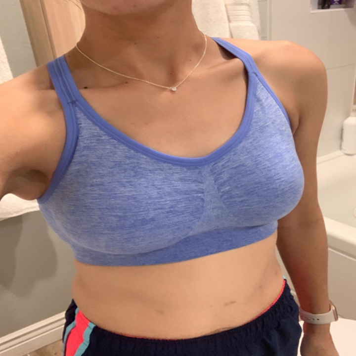 A reviewers wears a blue sports bra