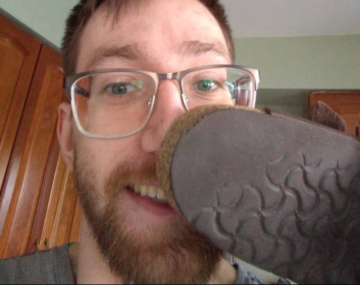 reviewer holds shoe up to nose