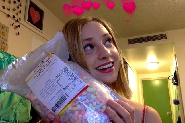 reviewer cradles large bag of marshmallows