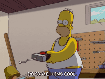 homer simpson pressing a big red button on remote and saying &quot;do something cool&quot;