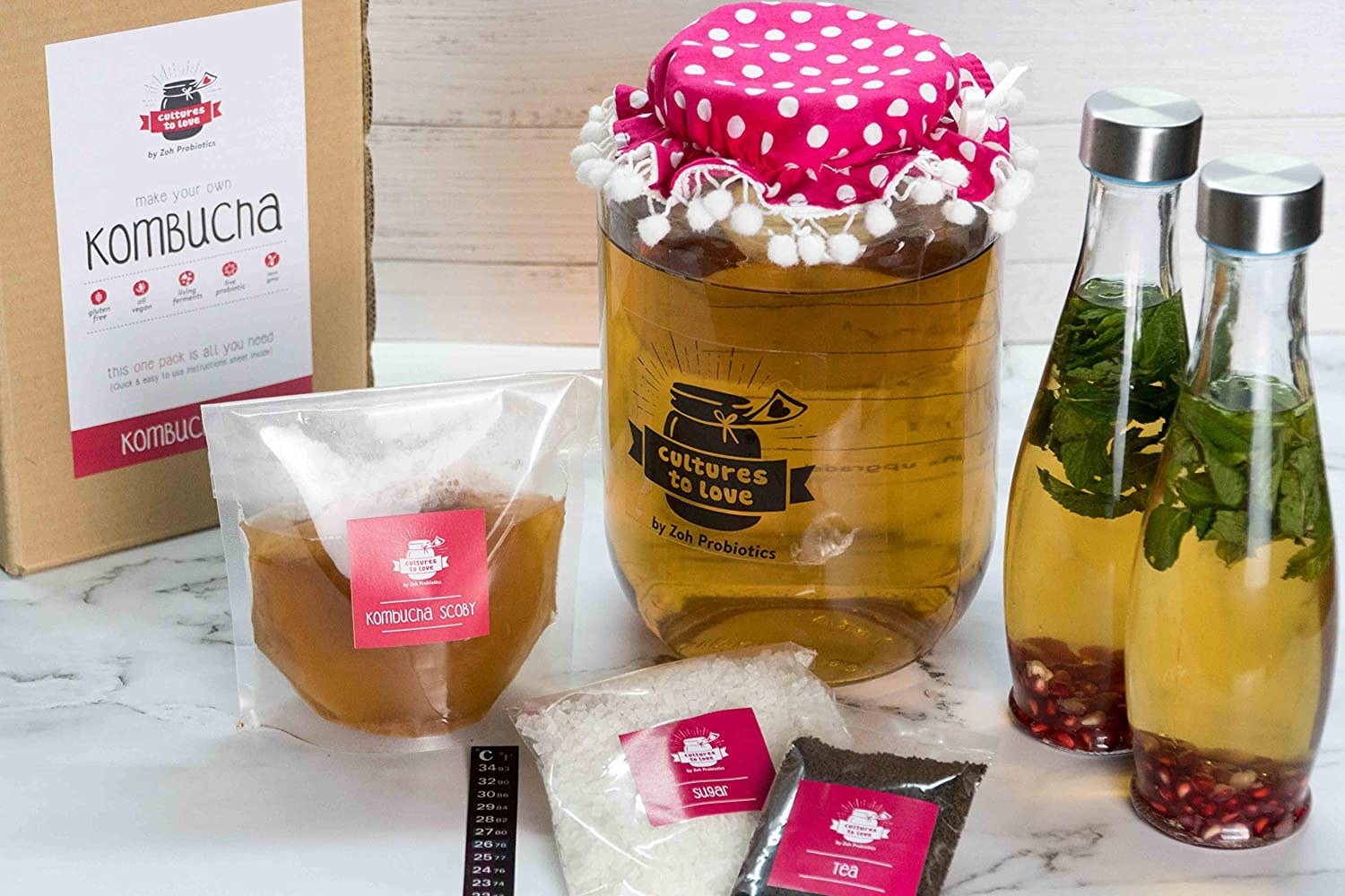 A kombucha brewing kit laid out on a counter.