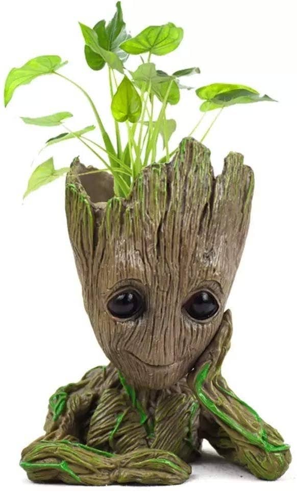 Groot rests his cheek on his hand with plants coming out of his skull
