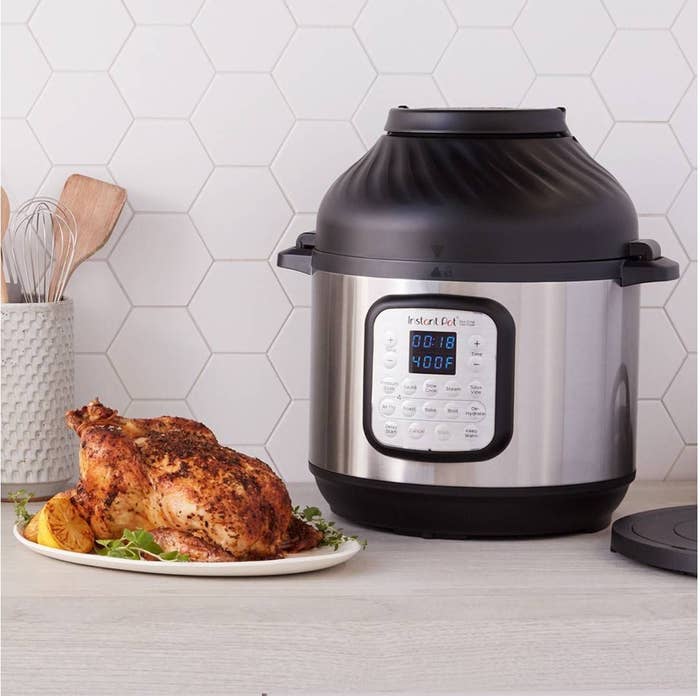 a silver instant pot with a black lid