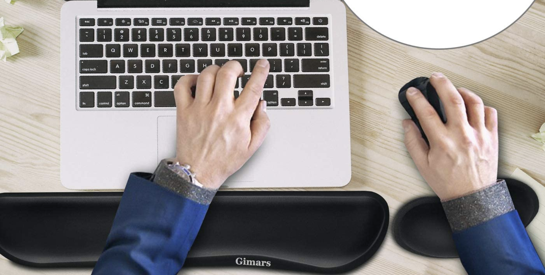 A model typing with one hand and using a mouse with the other, their wrists propped up by the pads