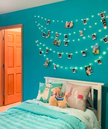 Reviewer shows same set of photo clip string lights in a blue bedroom