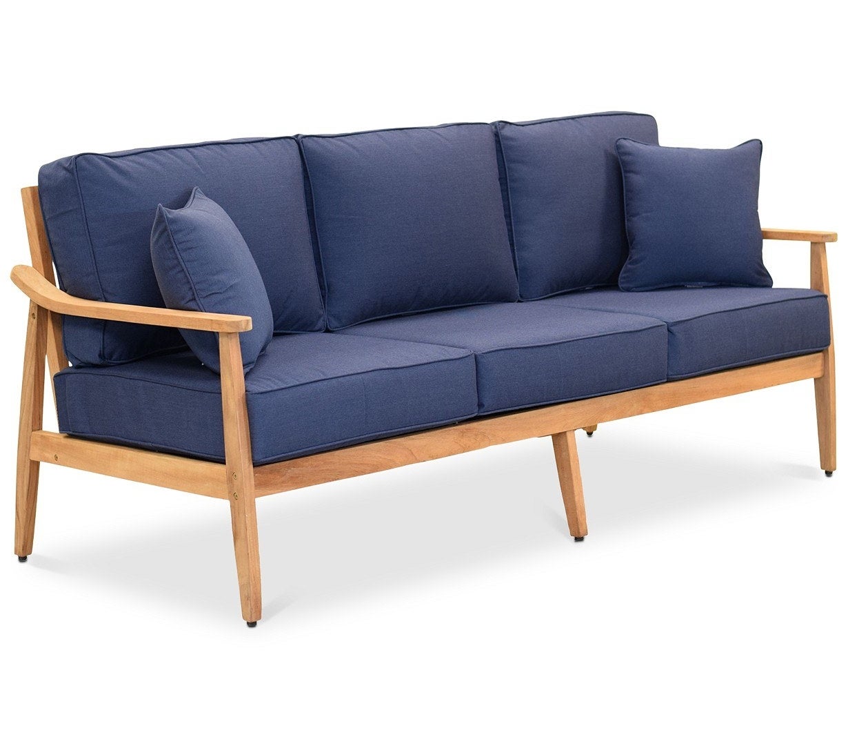 wood sofa frame with plush dark blue cushions and pillows