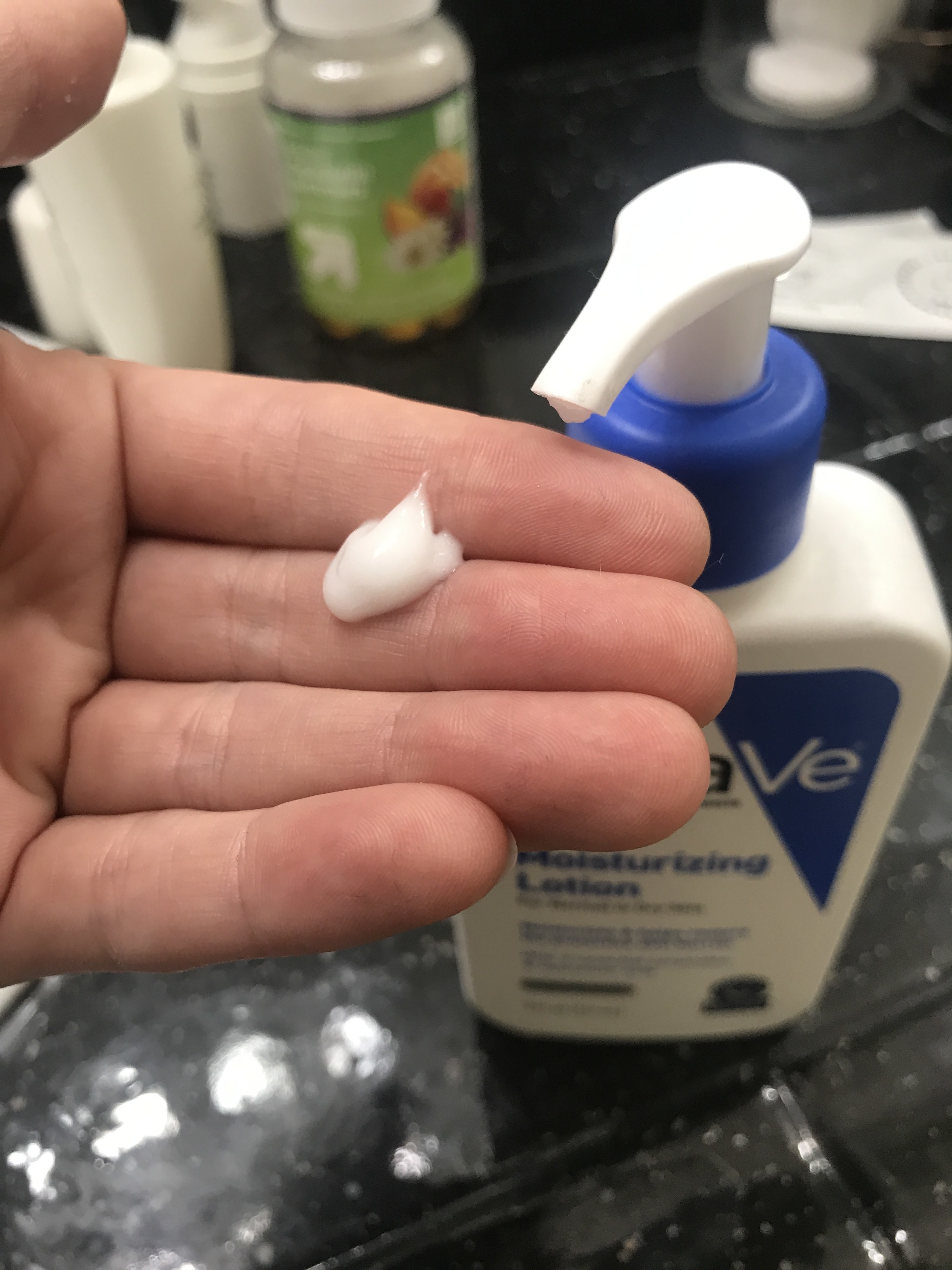Half a pump of Cera Ve lotion in an open hand