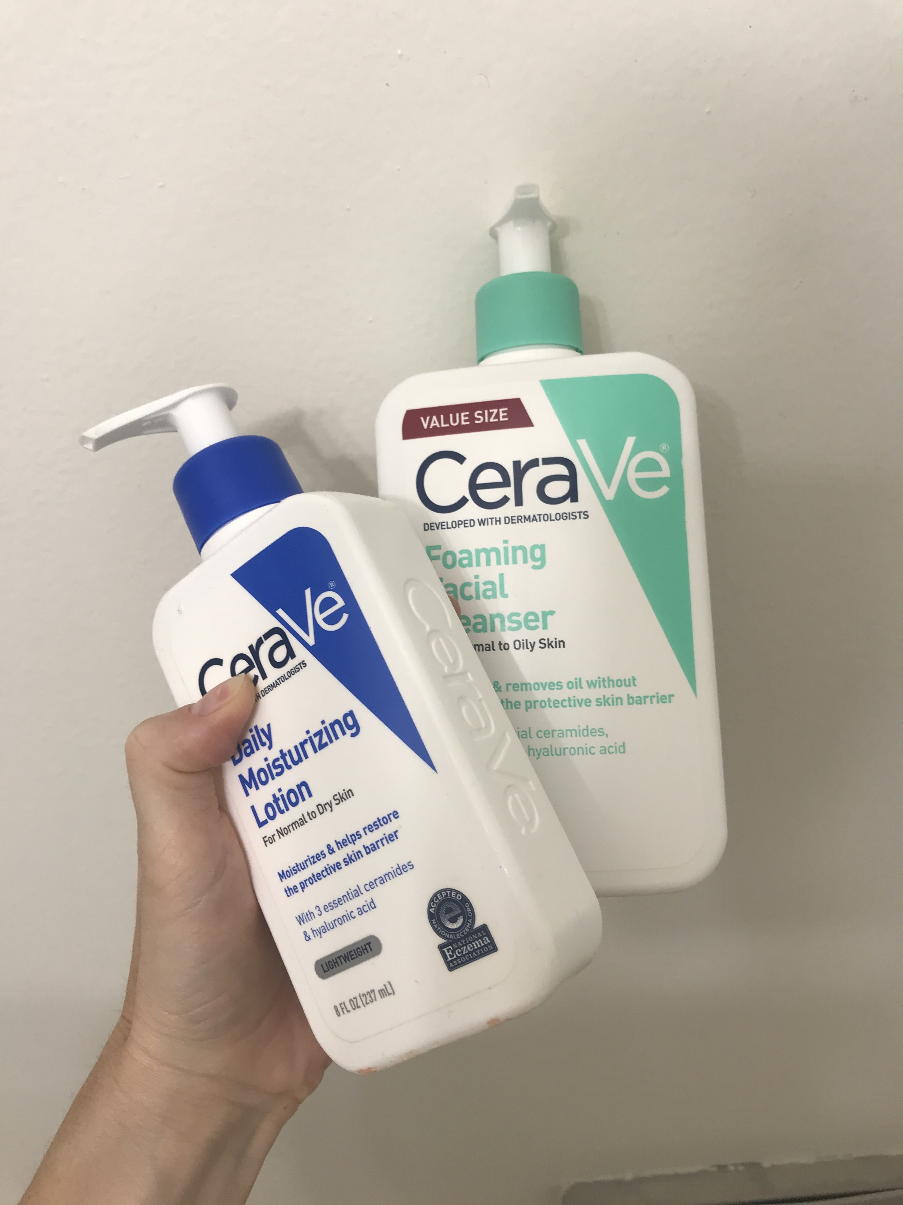 Hand holding Cera Ve products