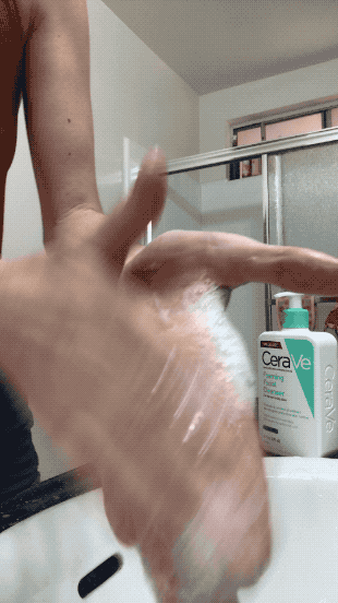 Foaming hand soap frothing between two hands