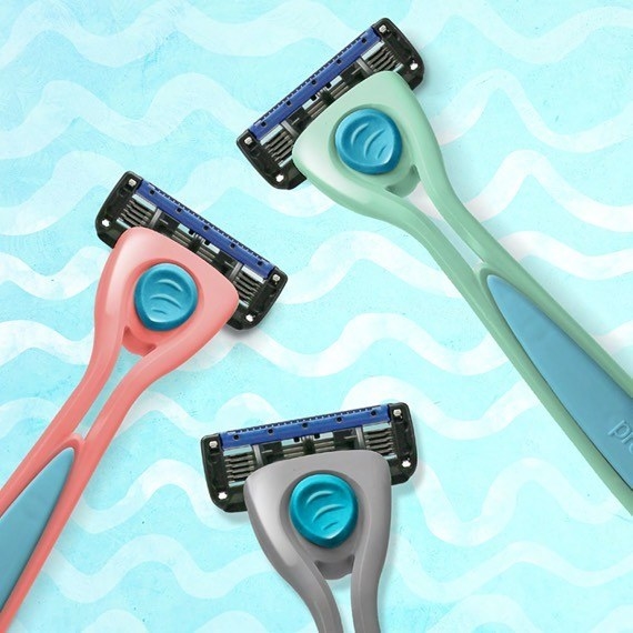 Three five-blade razors on a wavy background