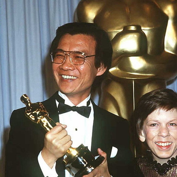 Ngor smiles and raises his best supporting actor oscar