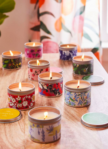 Colorful printed tin candles on a wooden table
