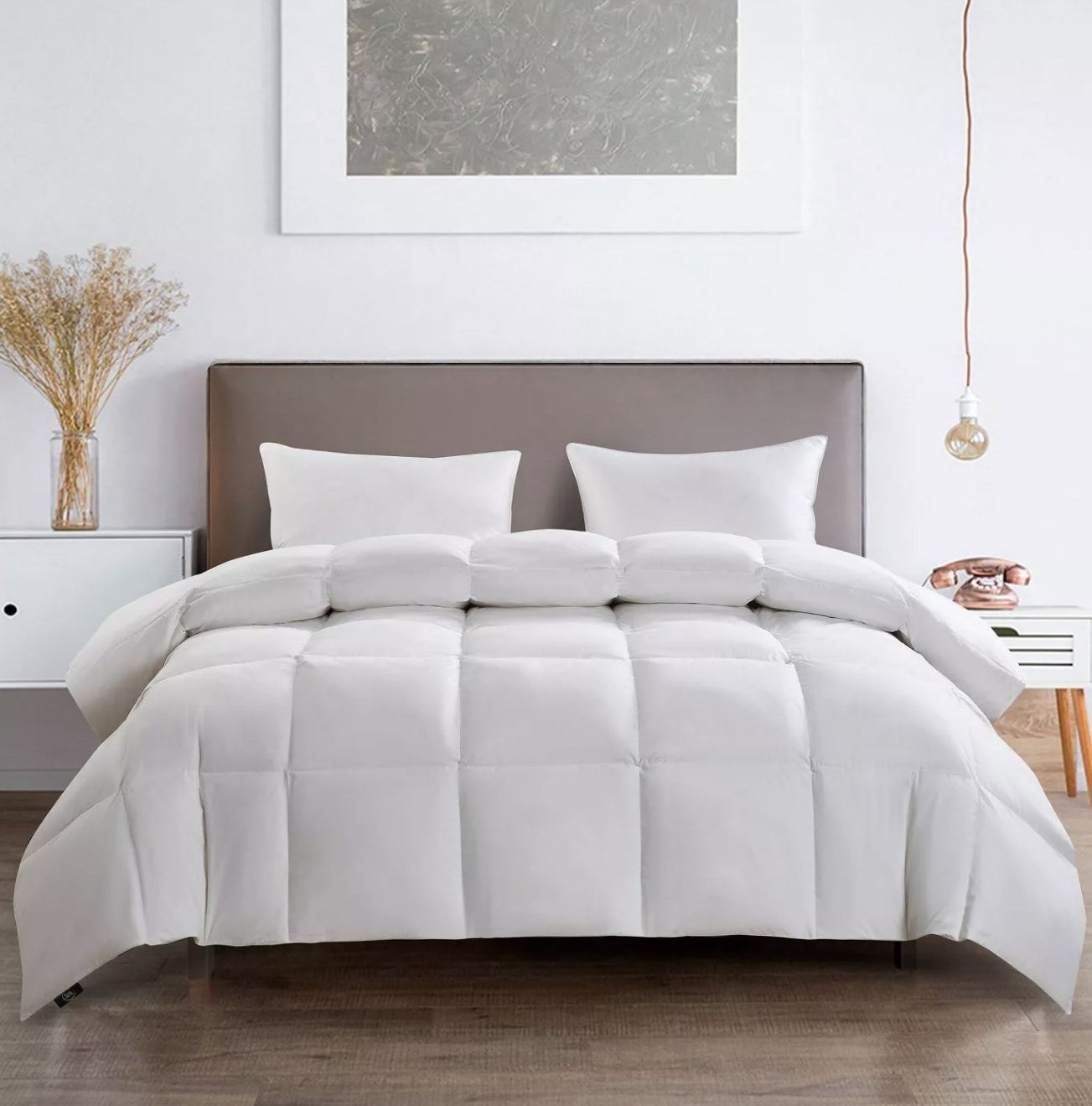 A quilted white comforter atop a bed 