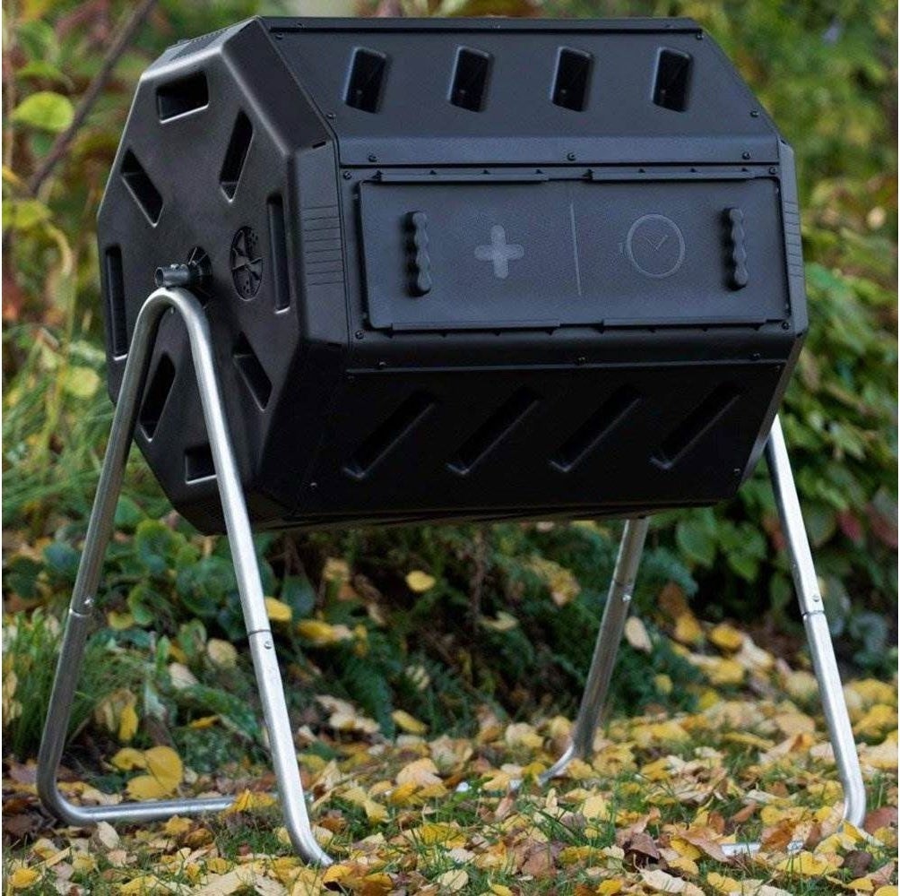 A black composter on metal legs 