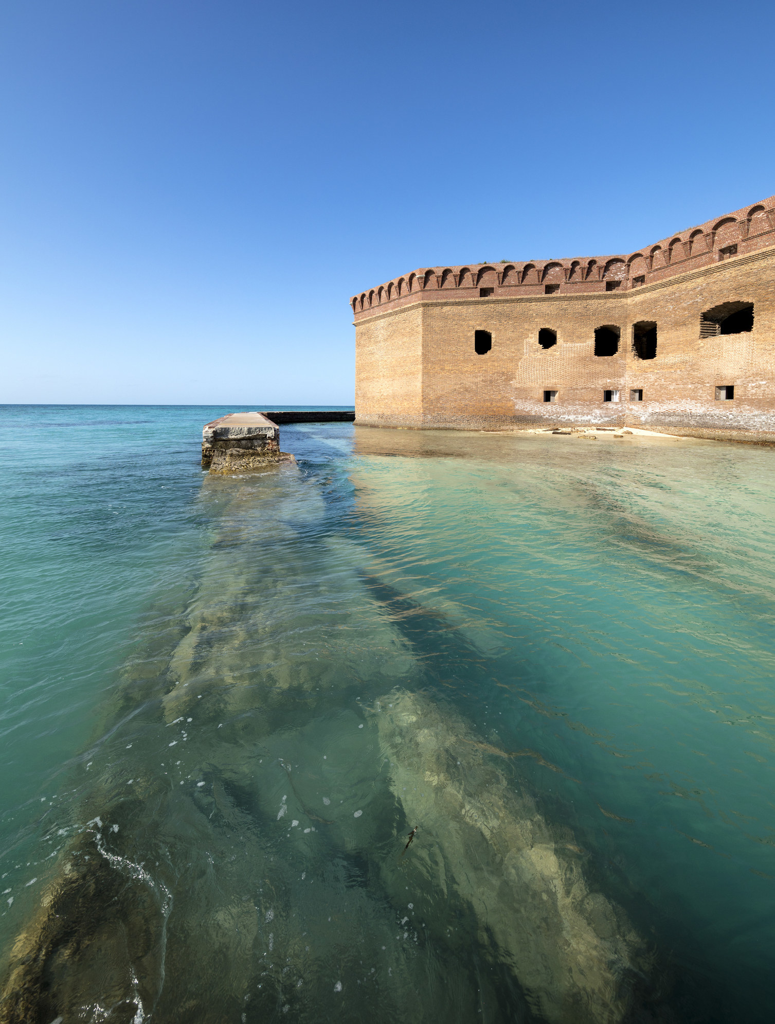 A view of Fort Jefferson and a moat surrounded by clear blue water at Dry Tortugas National Park.