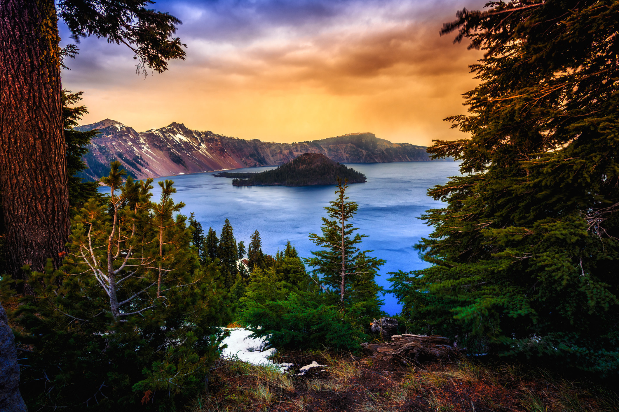 A colorful sunset over Crater Lake in Crater Lake National Park.