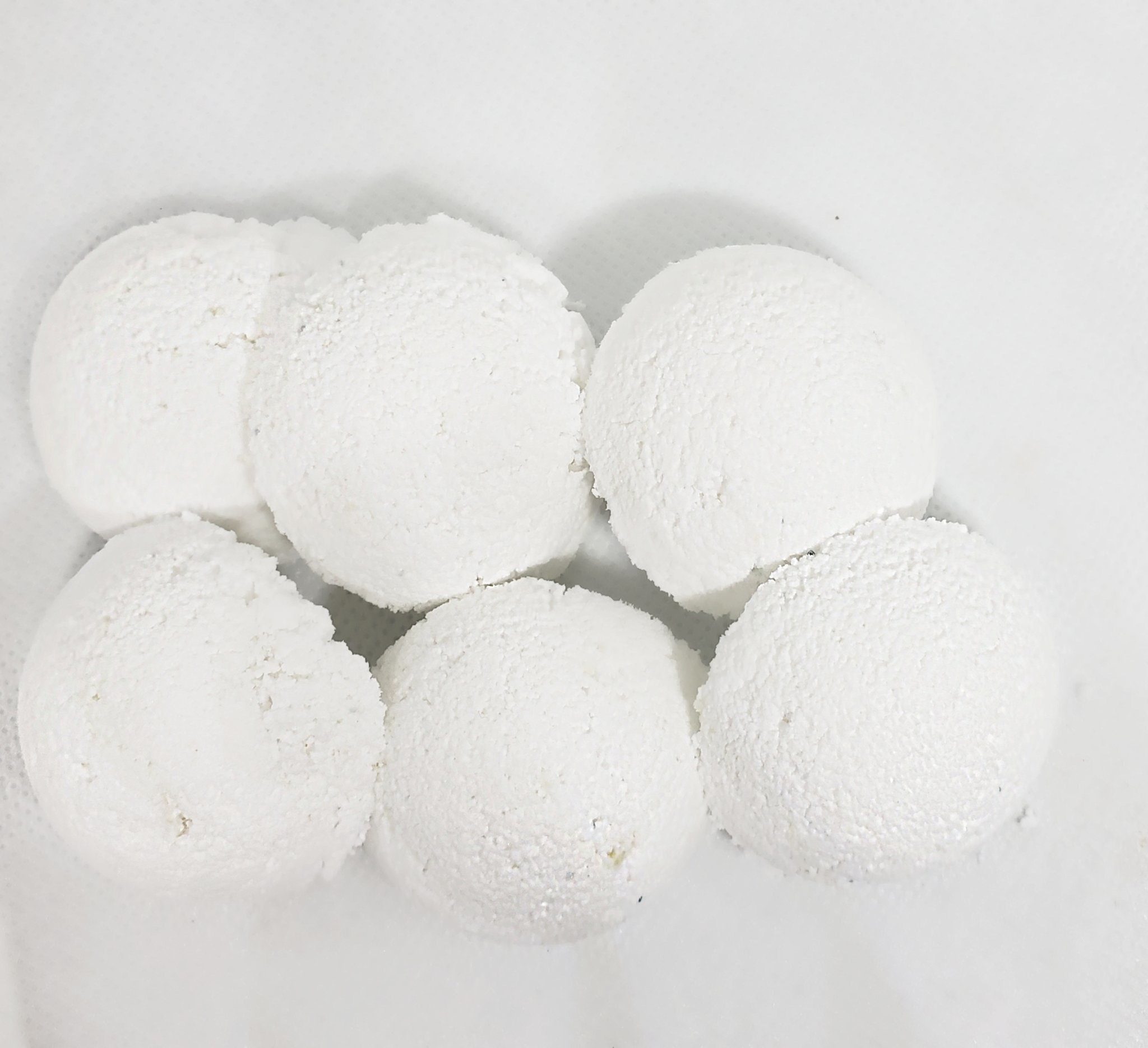 small white tablets shaped like snowballs