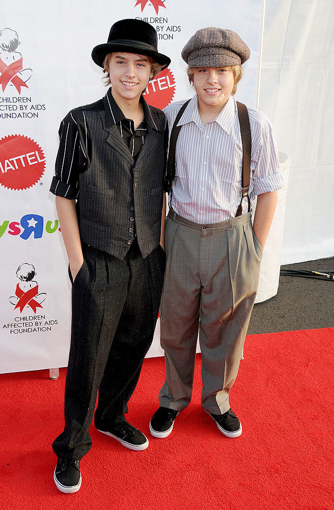 dylan and cole dressed in vests, slacks, and hats