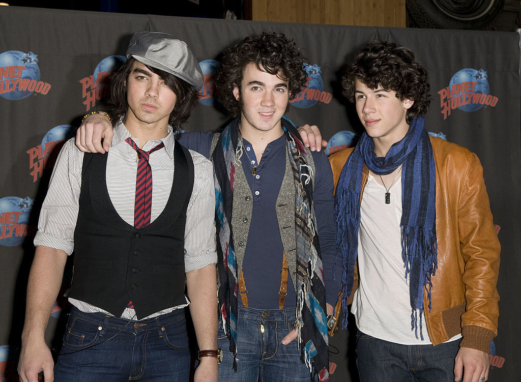 jonas dressed in lots of scarves and vests