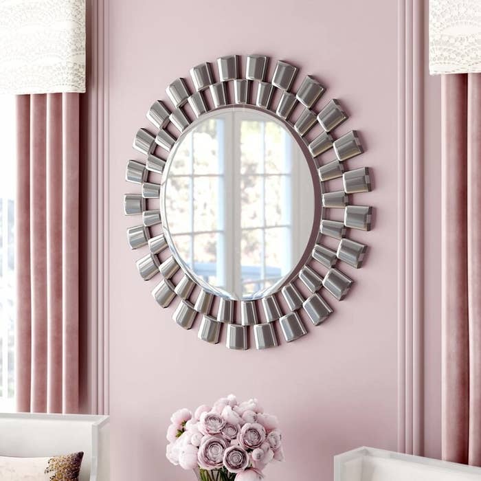 The large circular mirror with a staggered step frame