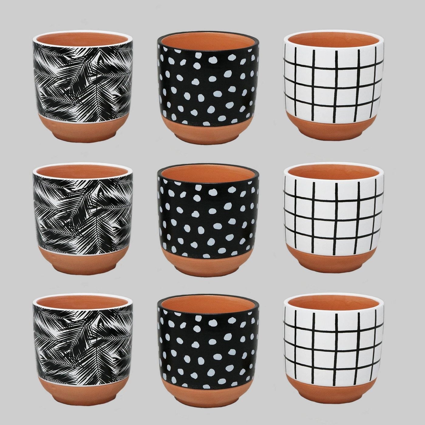 nine planters in 3 different black and white patterns 