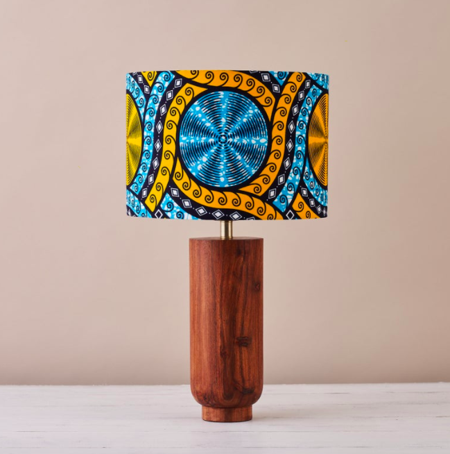 An African wax print drum lampshade in a blue and yellow geometric pattern