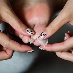 A close up of a person peeling dead skin off their big toe