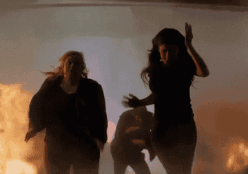 GIF of people outrunning an explosion