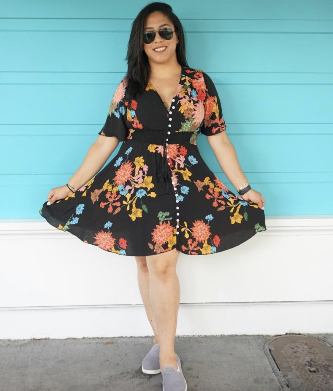 reviewer wearing black and floral V-neck mini dress 