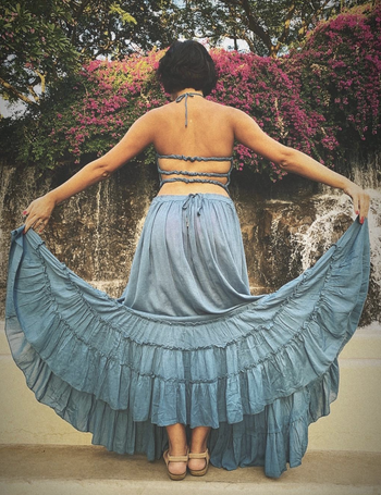 reviewer wearing light blue dress with three thin straps on the back