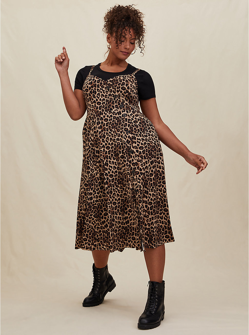model in the dress with asymmetrical buttons on top over a black tee