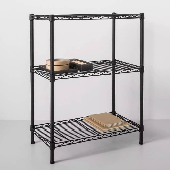 A three-level black wire metal shelf