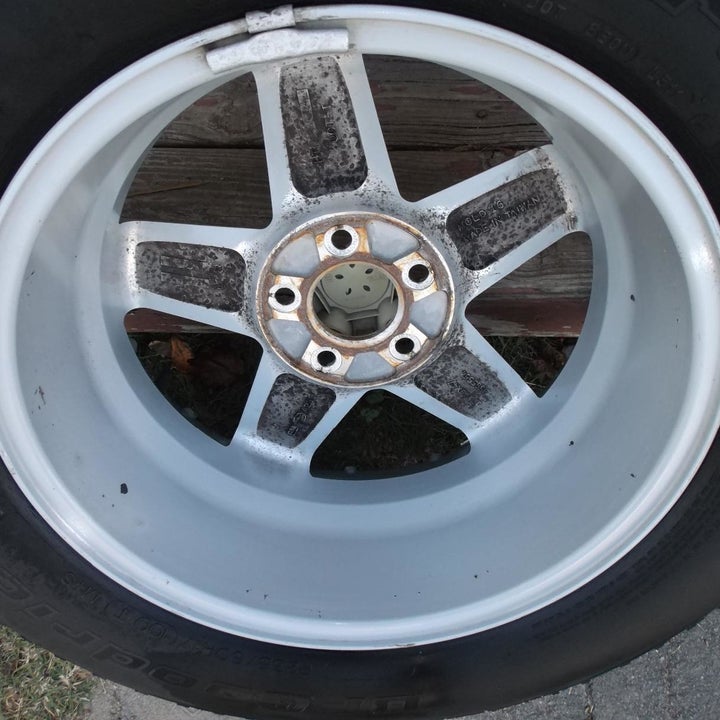 Same reviewer's photo showing the wheel cleaner was effective at getting rid of basically all the dirt and restoring the rim's shine