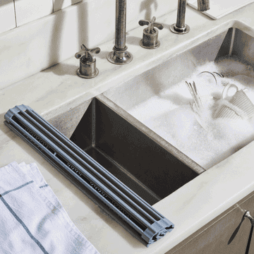 gif of the rack rolling out over a sink with utensils and dishes fit inside for drying