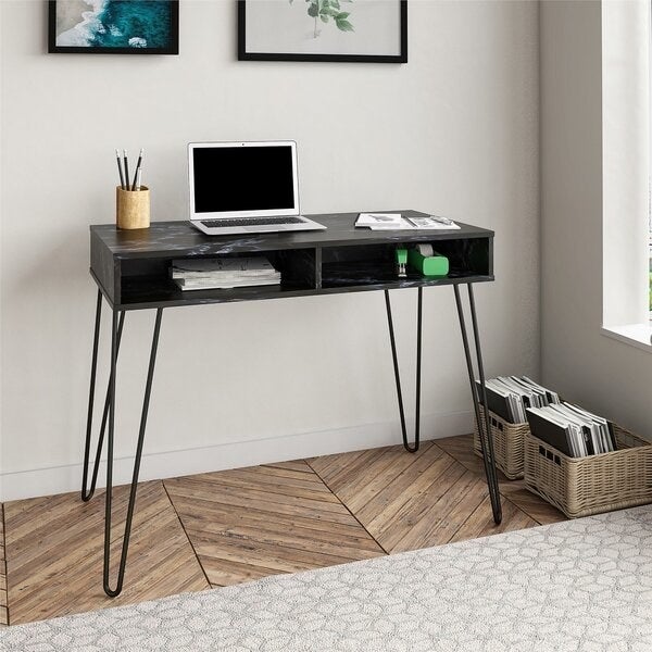 The black wooden desk with two open drawers