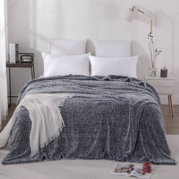 A furry blue blanket atop a bed