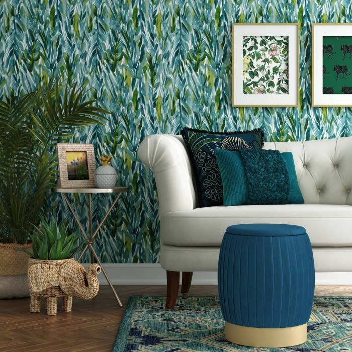 The teal round ottoman with gold base