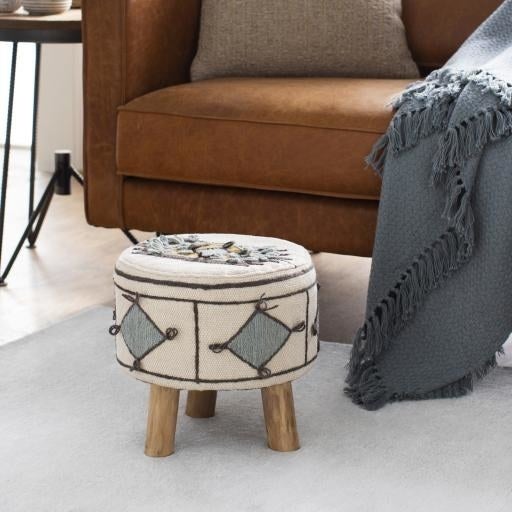 The white cotton stool with blue diamond pattern and wooden legs