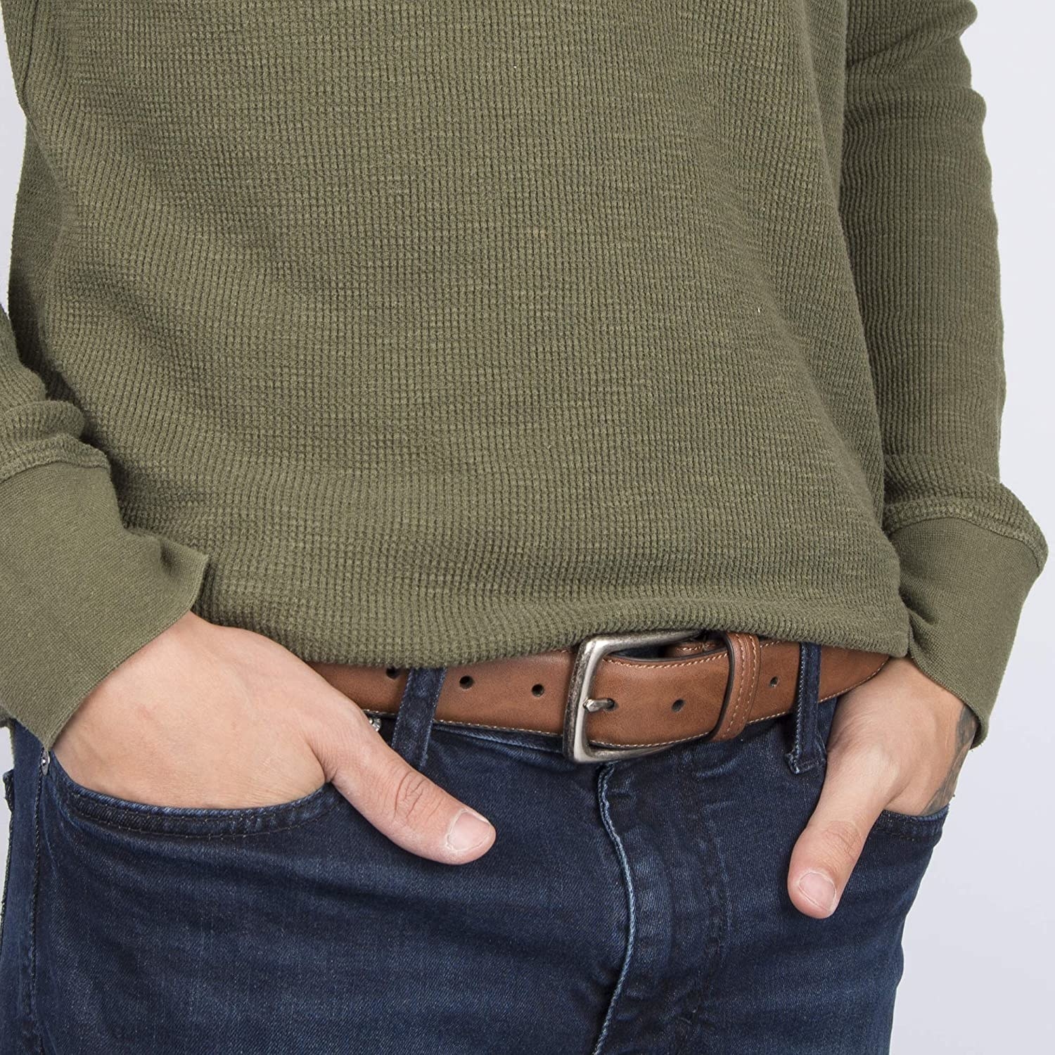 A person wearing the belt with their hands in their pockets