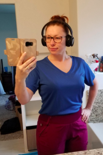 Reviewer wears dark blue v-neck moisture-wicking tee with red joggers