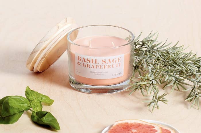 a pale pink colored double wick glass candle