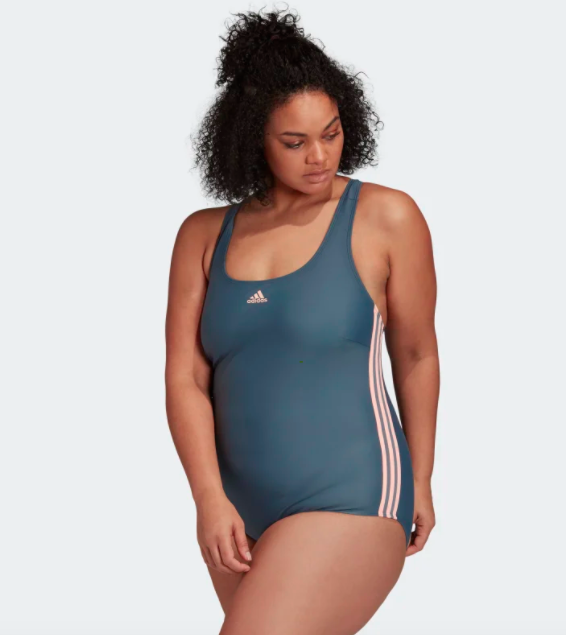 Model wears blue Adidas one-piece swimsuit with orange stripes on the side