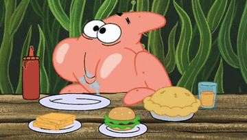Patrick from Spongebob chewing a whole lot of food and looking very pleased about it 