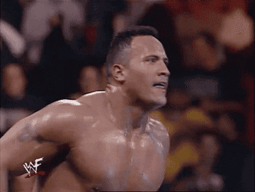 A GIF of The Rock in a wrestling ring smelling what he is cooking.