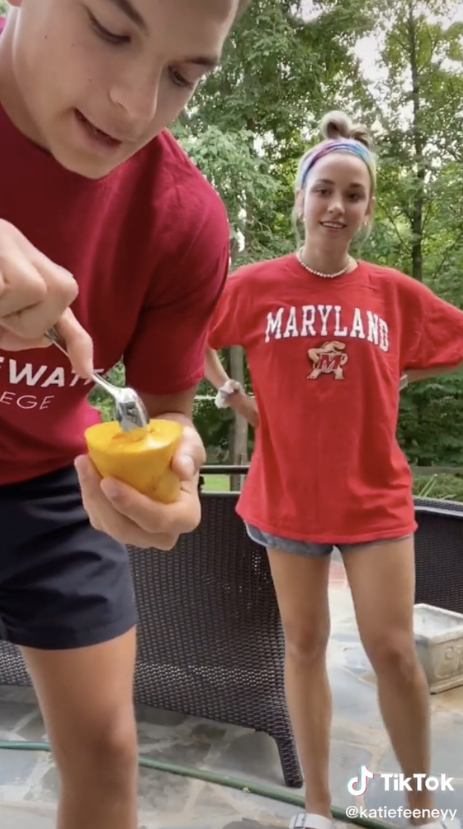 Sean scooping out the additional parts of each half of the mango.