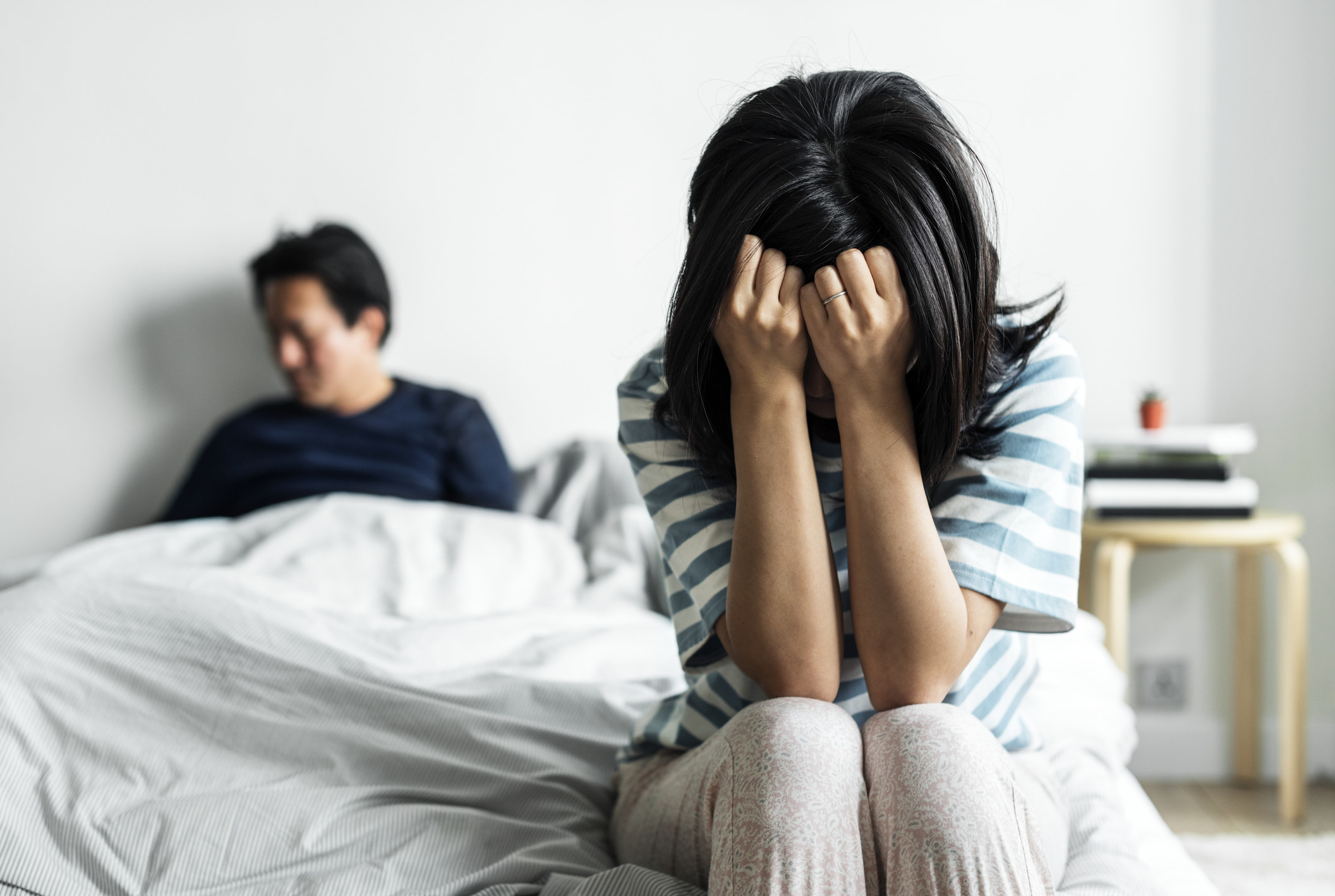 Photo of a couple arguing in bed