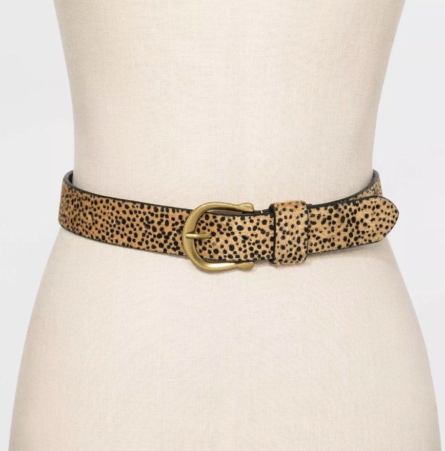 a leopard print belt with a gold buckle