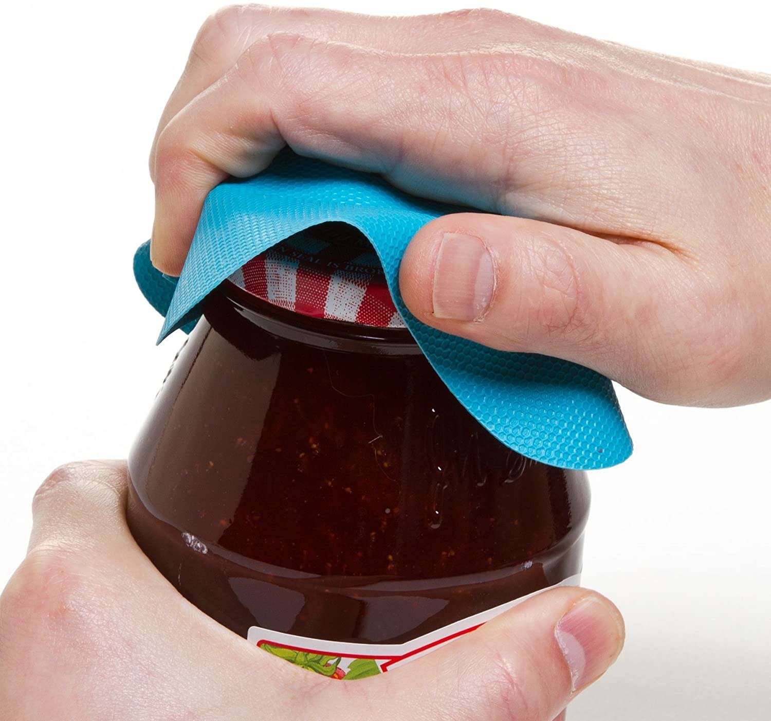 A person using a small rubber coaster to open a jar of jam