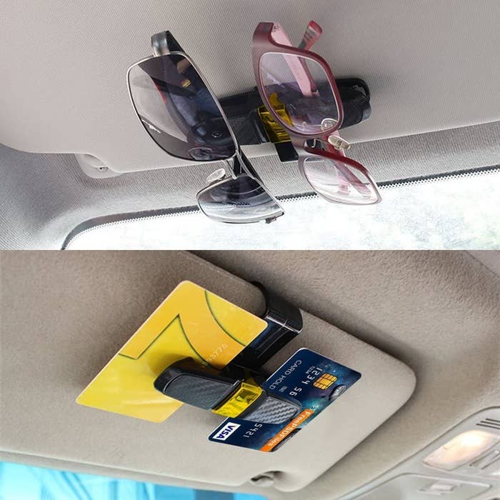 One sun visor clip holding two pairs of glasses and another holding two credit cards